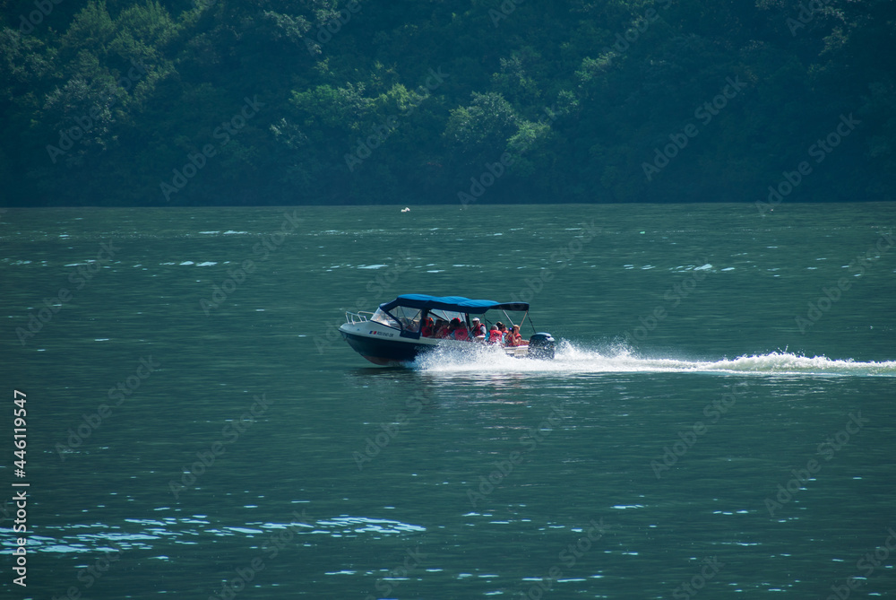 Fototapeta premium Cruise ship for tourists who come to see the Danube river. Tourists admire the landscapes of the Danube.Romaniam, Orsova. July, 18, 2021