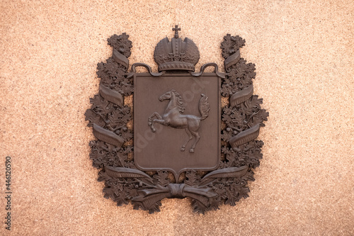coat of arms, symbol of the city of Tomsk on a granite wall. Russia Siberia