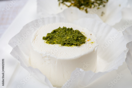 Cheese collection, variety of fresh white soft goat French cheeses with green pesto