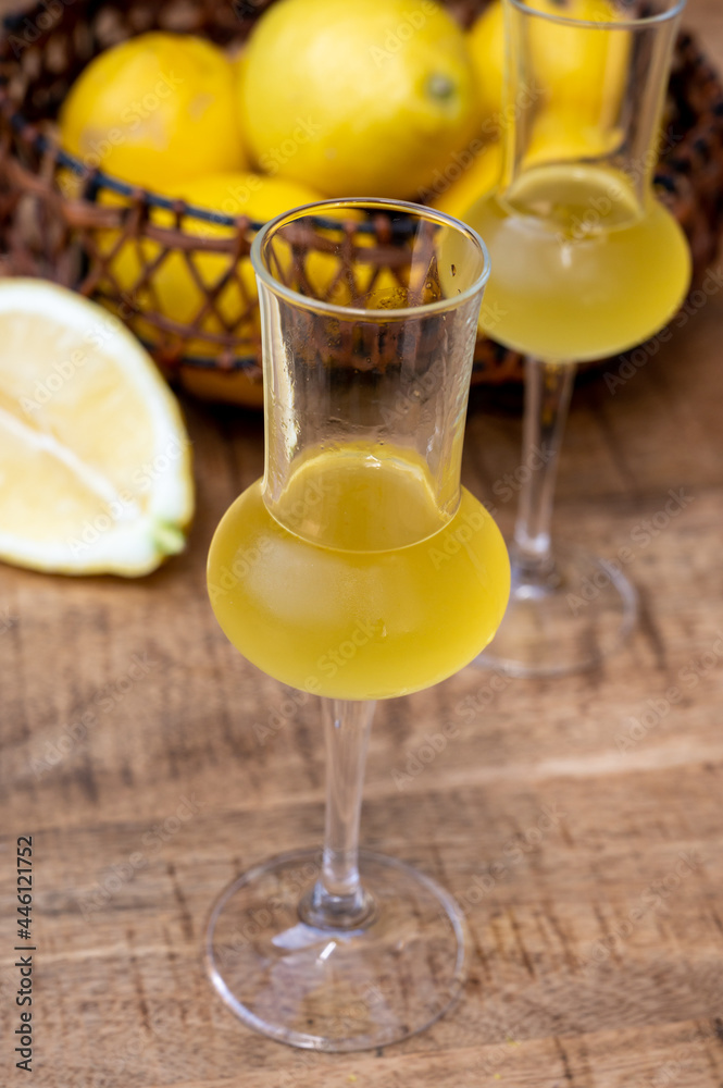 Fototapeta premium Glasses of cold sweet italian strong alcoholic liquor limoncello made from fresh lemons.