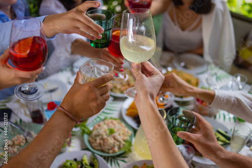 Clinking glasses with alcohol and toasting, party. photo