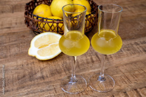 Glasses of cold sweet italian strong alcoholic liquor limoncello made from fresh lemons.