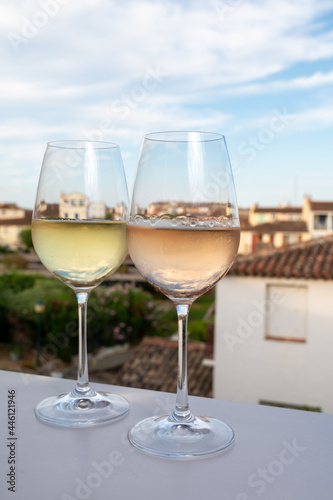Summer on French Riviera Cote d'Azur, drinking cold rose and white wine from Cotes de Provence on outdoor terrase in Port Grimaud, Var, France