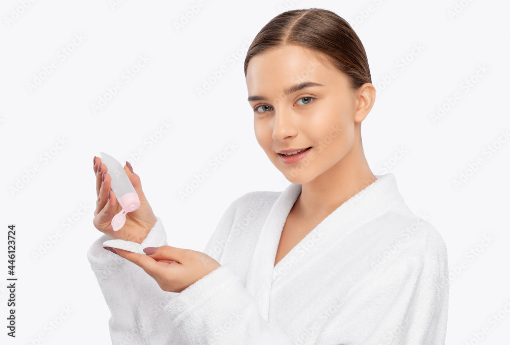 Beautiful smiling woman with clean skin holds a cotton pad. She cleanses the skin with a tonic. Cosmetology and professional skin care. Beautiful smiling woman with clean skin holds a cotton pad. She cleanses the skin with a tonic. Cosmetology and professional skin care.