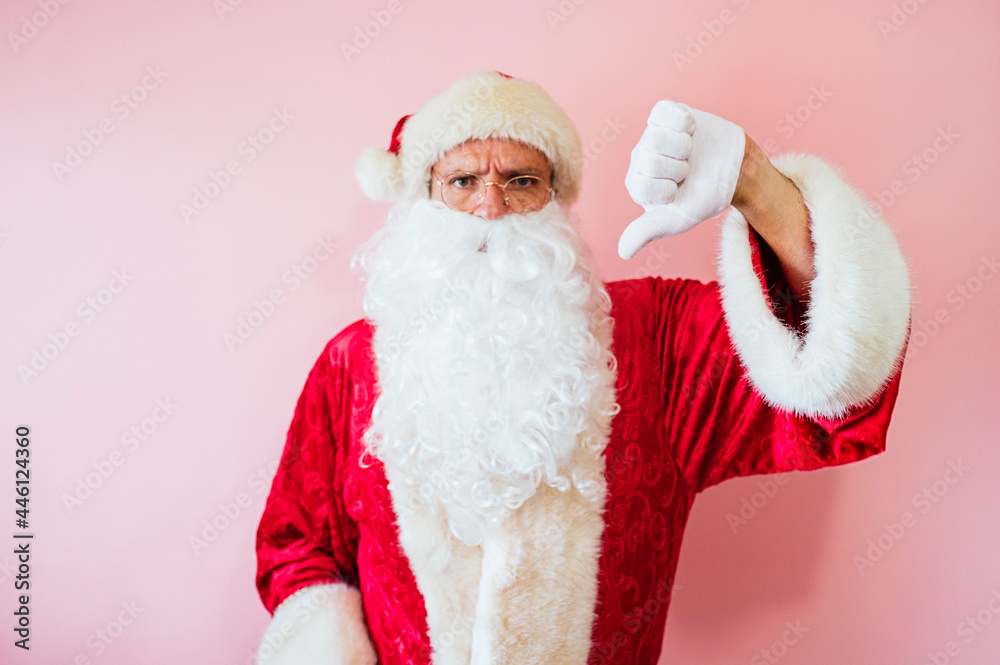 Man dressed as Santa Claus making negativity gesture with finger down