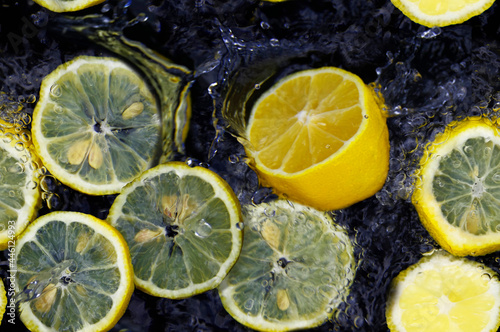 Seamless pattern with yellow lemons with water.