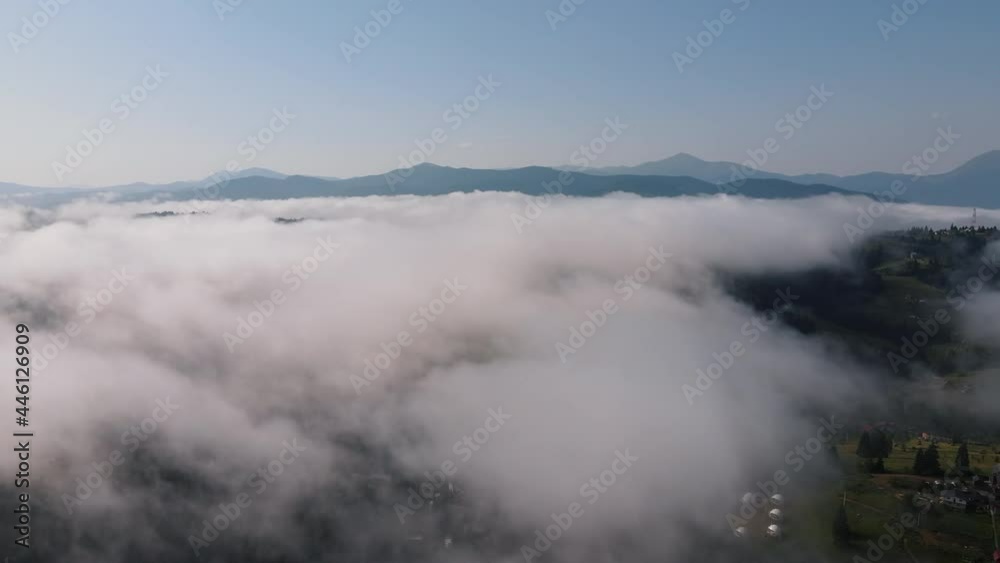 Aerial view drone shot of flowing fog waves on mountains forest, Amazing beautiful nature background with clouds, countryside and summer mountain peaks at sunny morning day. Wanderlust destination Aerial view drone shot of flowing fog waves on mountains forest, Amazing beautiful nature background with clouds, countryside and summer mountain peaks at sunny morning day. Wanderlust destination