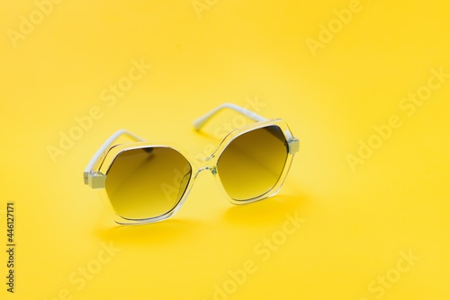 yellow sunglasses on yellow background
