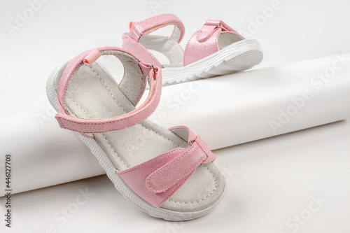 Pink insulated sandals. Children's pink sandals with white soles and Velcro fasteners isolated on a white background. Fashionable children's shoes for children. 