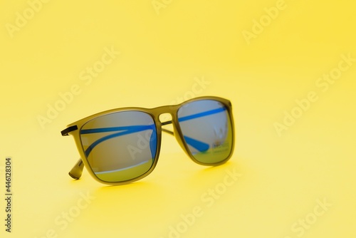 Stylish sunglasses on a yellow background High quality photo Sunglasses.