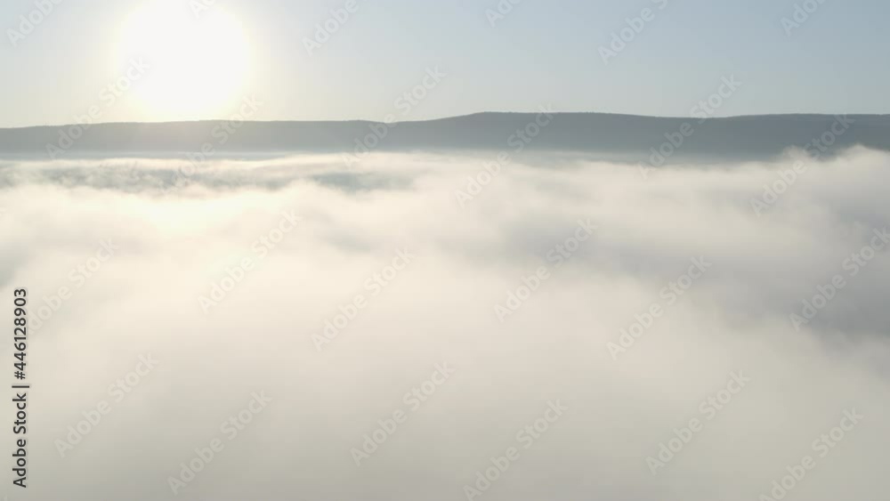 Camera pans up toward cloud covered residential community Camera pans up toward cloud covered residential community