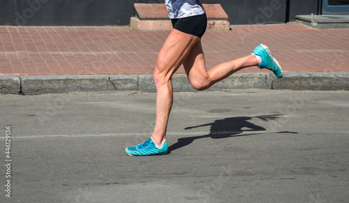 Runner fitness woman feet running on road. jog workout wellness concept.