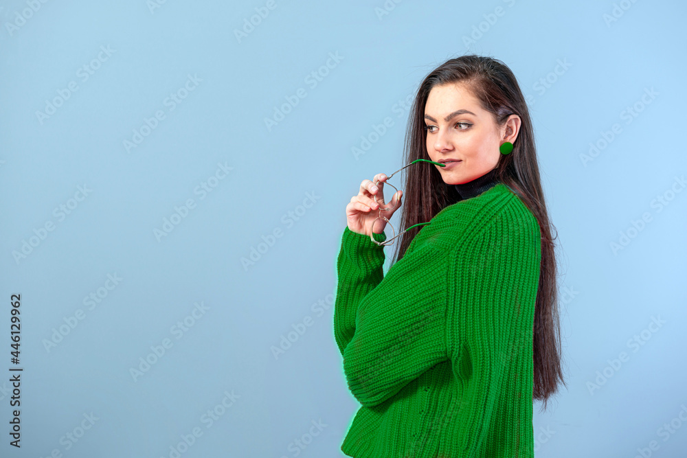 young emotional teenage female with glasses dressed in a red sweater posing on a gray background young emotional teenage female with glasses dressed in a red sweater posing on a gray background