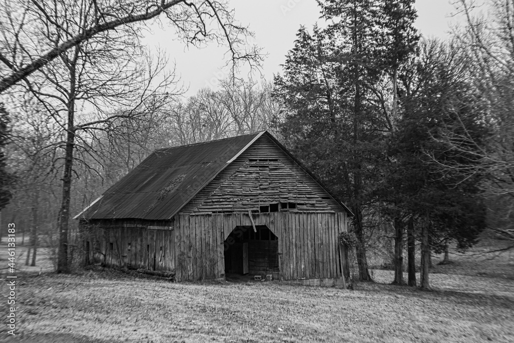 abandoned barn with snow during winter in monochrome with winter weather in background abandoned barn with snow during winter in monochrome with winter weather in background