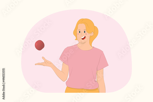 Young healthy vegan girl throws up apple fruit concept