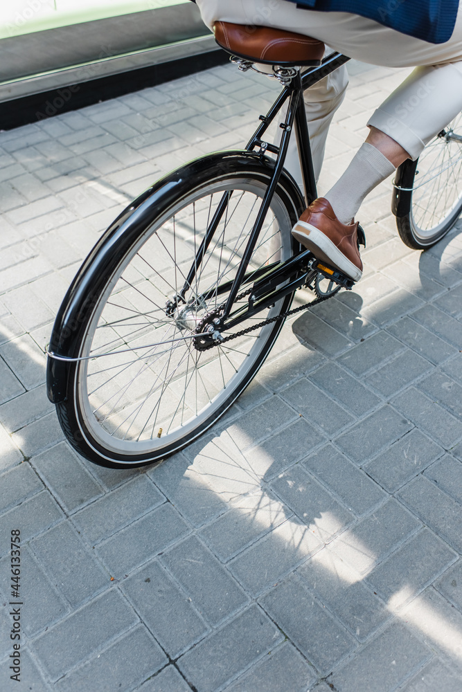 cropped view of man riding bicycle outside