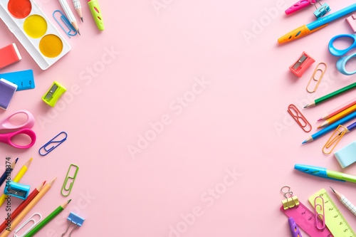 Flat lay colorful school stationery on pink background. Back to school concept. Kid desk top view