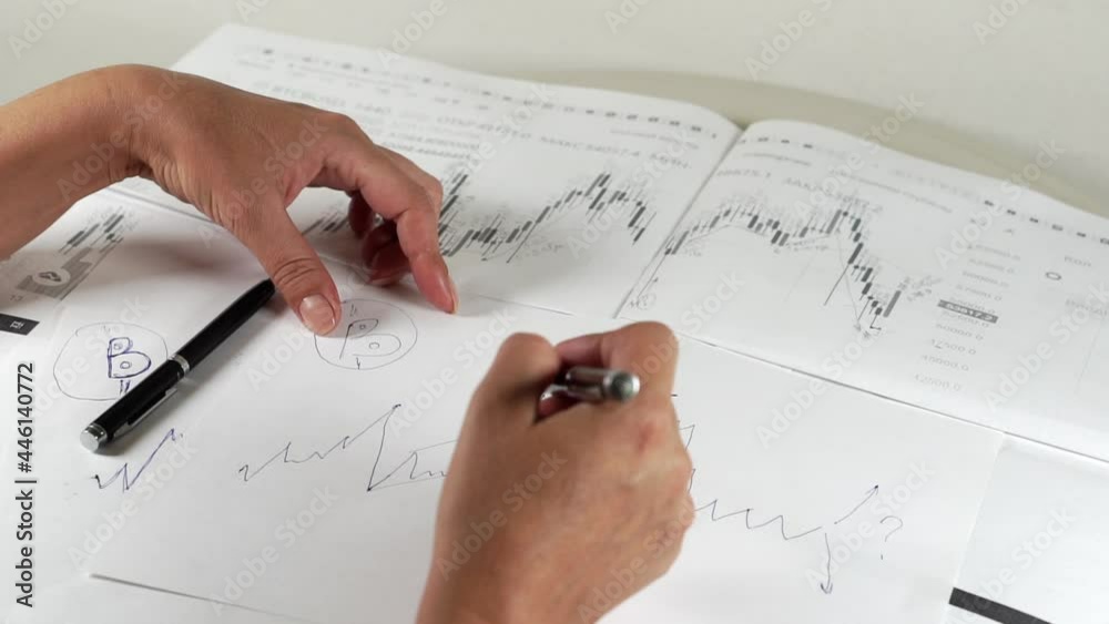 Bitcoin Stock Chart Analysis: A broker, trader or investor is analyzing a cryptocurrency stock chart. Bitcoin Stock Chart Analysis: A broker, trader or investor is analyzing a cryptocurrency stock chart.