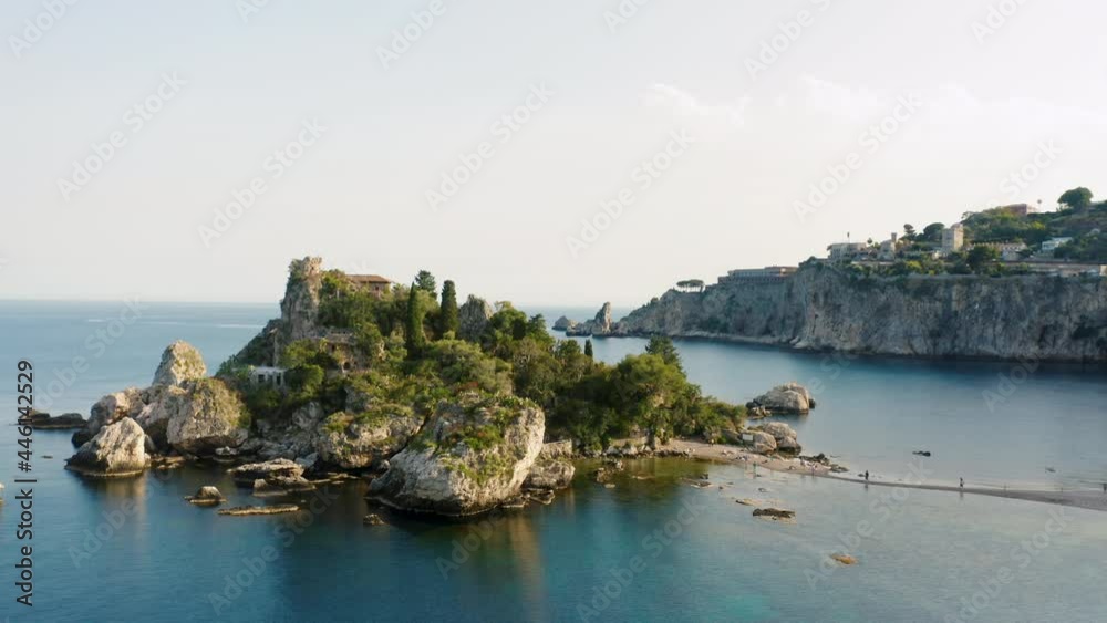 Aerial view of Isola Bella near Taormina travel destination in Sicily, Italy. Orbital drone shot of iconic mediterranean sea town coast line. Aerial sunset cityscape Aerial view of Isola Bella near Taormina travel destination in Sicily, Italy. Orbital drone shot of iconic mediterranean sea town coast line. Aerial sunset cityscape