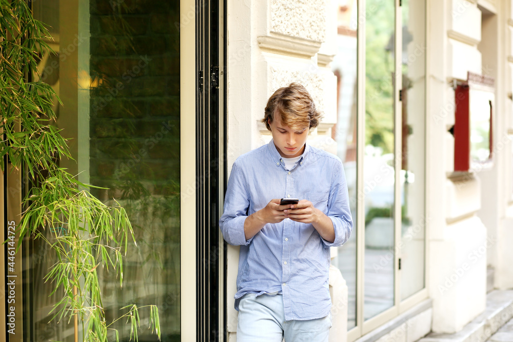 Portrait of attractive teenage boy standing in front of a brick wall. Portrait of attractive teenage boy standing in front of a brick wall.