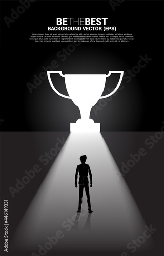 Silhouette businessman standing in light from exit door shape trophy. Business Concept of route to winner and champion