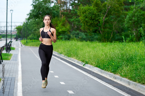 Running asian woman on running track. Morning jogging. The athlete training