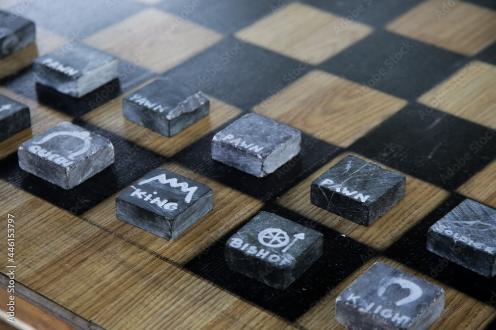 Minimal design stone chess figures on the board Minimal design stone chess figures on the board