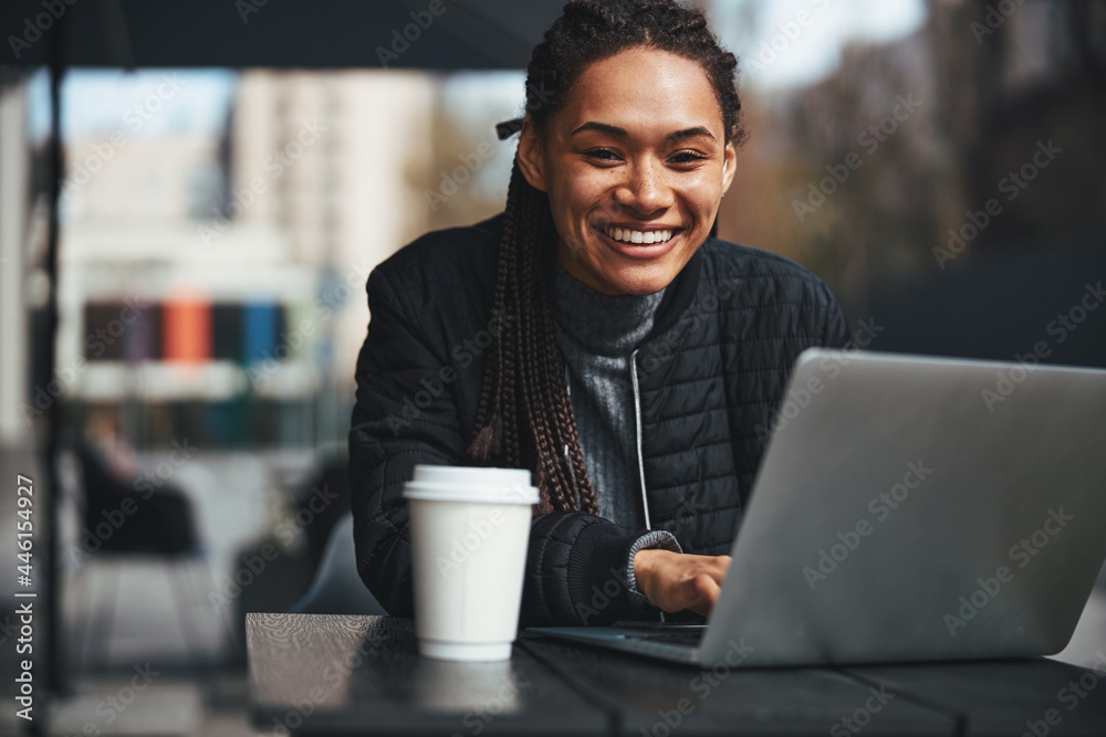 Happy lady with modern gadget sitting outdoors
