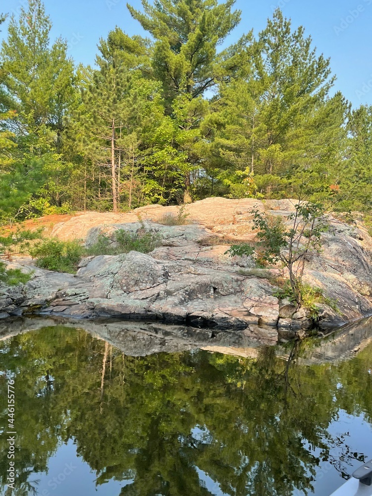 river in the gorge. Reflection of trees over rocky shoreline Minnesota river in the gorge. Reflection of trees over rocky shoreline Minnesota