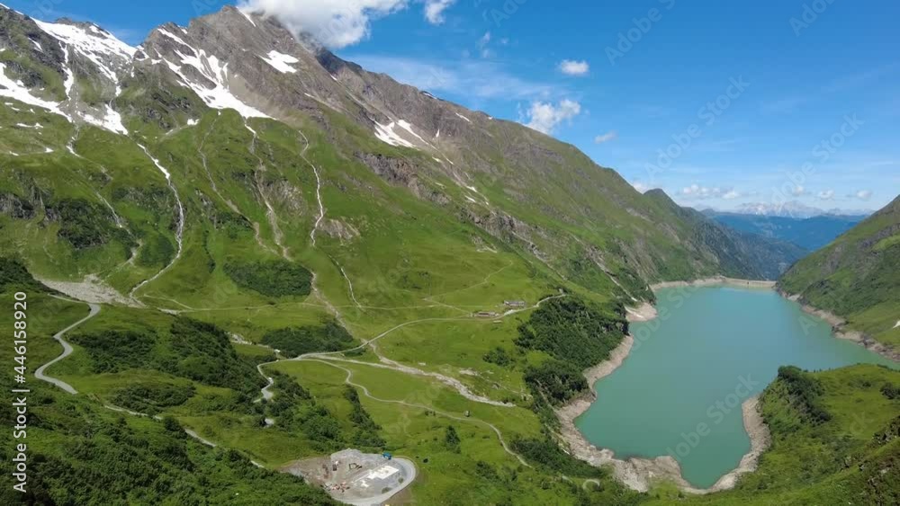 Reservoir and dam Kaprun. Mountaineers against the wall of the dam Reservoir and dam Kaprun. Mountaineers against the wall of the dam