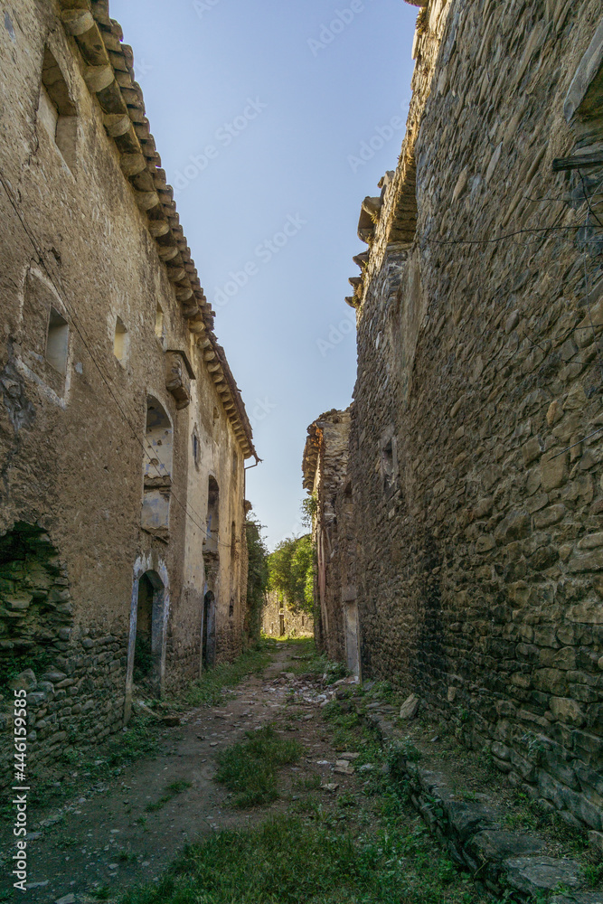 empty street and houses in abandoned village in the Pyrenees, Janovas, Spain