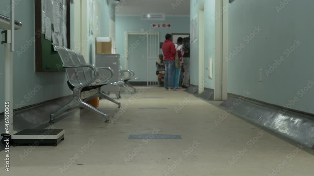 Tilt-up to patients waiting to see a doctor, at waiting area, in a government hospital in Johannesburg, South Africa.