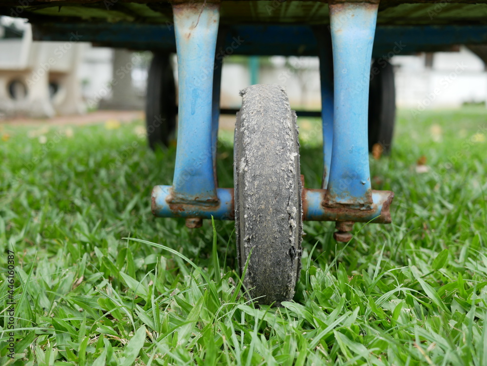 Fototapeta premium closeup of old black cart wheels in the garden.