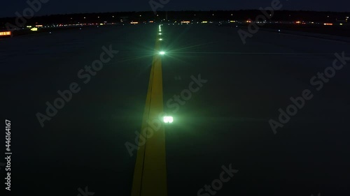Green lights on airport runway at night photo