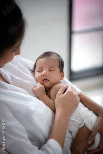 young mother holding child ...