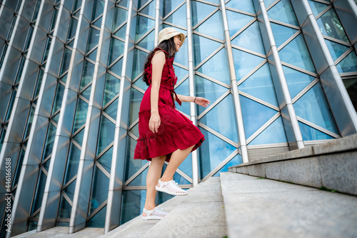 Asian woman in red dress at...
