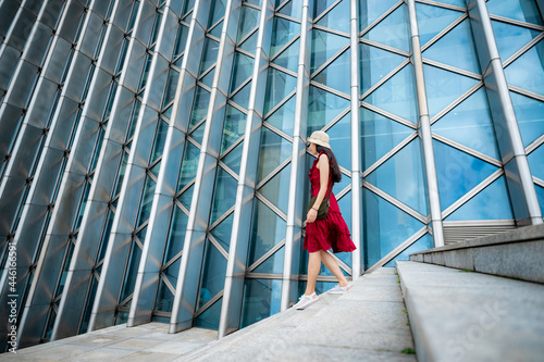 Asian woman in red dress at...