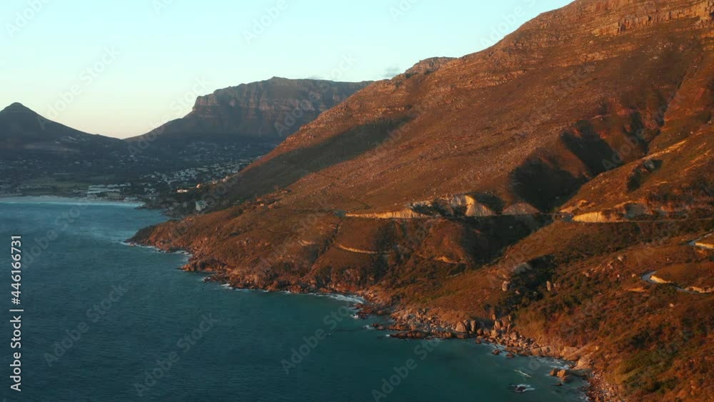 Rugged Landscape Of Chapman's Peak With A Distant View Of Houtbaai Suburb In Cape Town, South Africa. aerial Rugged Landscape Of Chapman's Peak With A Distant View Of Houtbaai Suburb In Cape Town, South Africa. aerial