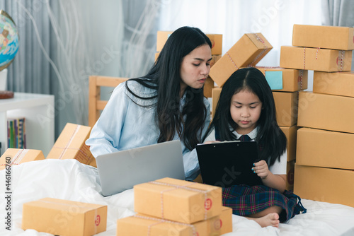 young woman person packing product to a delivery box, female business owner entrepreneur are happy with online e-business at home © chokniti