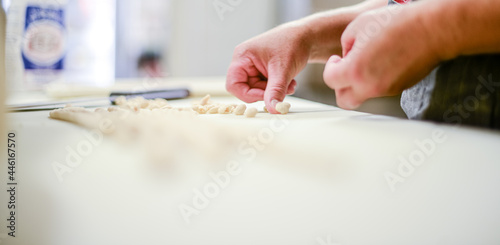 Chef preparing Pisarei traditional italian pasta from Piacemza, Italy made of breadcumbs, flour, water and salt. photo