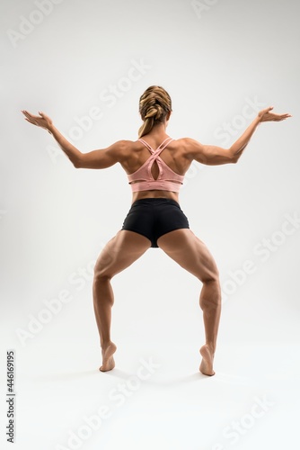 Muscular woman in sports underwear standing in Goddess pose © Wisky