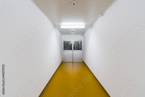 Interior worker corridor and aluminum door with Epoxy floor coating for cleanroom, Food Factory, Manufacturing Pharmaceutical Plant, Cosmetic Factory.