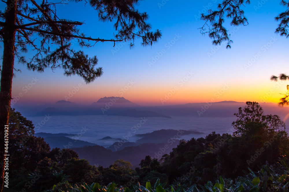 landscape view of mountain over sea of mist at sunrise
