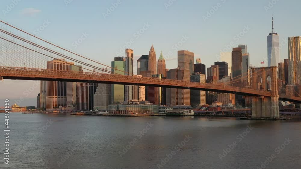 An aerial view over the East River on a beautiful morning. The camera pan left and truck right facing the Brooklyn Bridge, taking in the amazing New York City skyline. An aerial view over the East River on a beautiful morning. The camera pan left and truck right facing the Brooklyn Bridge, taking in the amazing New York City skyline.