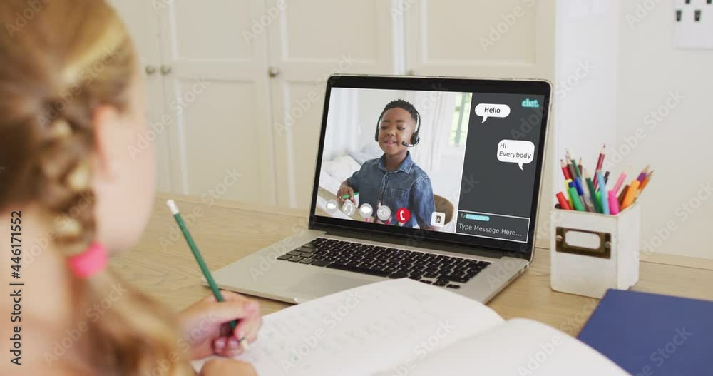 Schoolgirl using laptop for online lesson at home, with her colleague and web chat on screen Schoolgirl using laptop for online lesson at home, with her colleague and web chat on screen