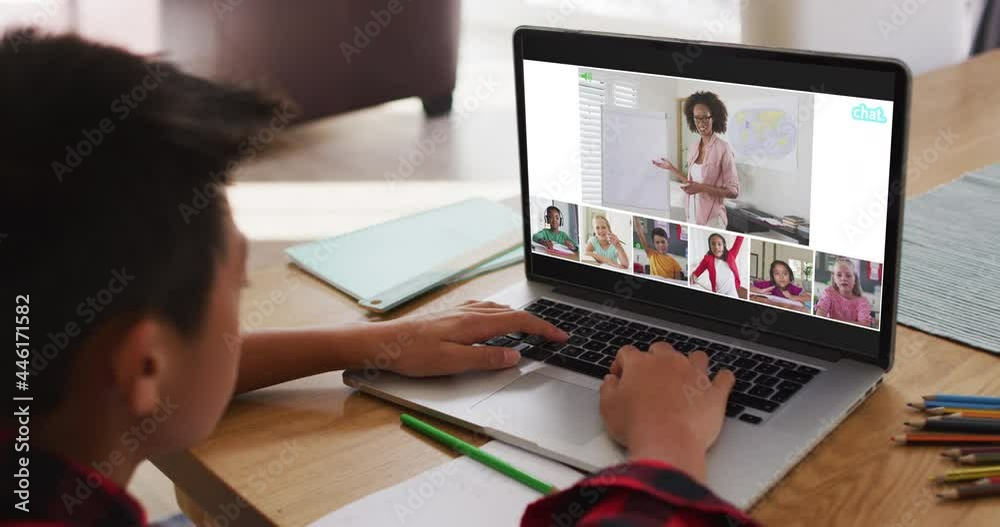 Schoolboy using laptop for online lesson at home, with diverse teacher and class on screen Schoolboy using laptop for online lesson at home, with diverse teacher and class on screen