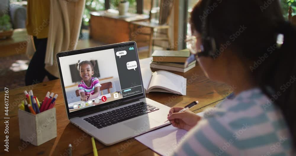 Schoolgirl using laptop for online lesson at home, with her colleague and web chat on screen Schoolgirl using laptop for online lesson at home, with her colleague and web chat on screen