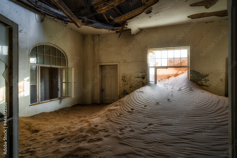 Abandoned building being taken over by encroaching sand in the ghost town of Kolmanskop near Luderitz, Namib Desert, Namibia.