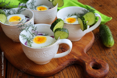 Cold soup with cucumbers, yogurtl and fresh herbs on the wooden rustic table