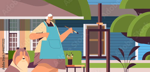 senior woman artist with dog painting picture creative hobby concept portrait horizontal